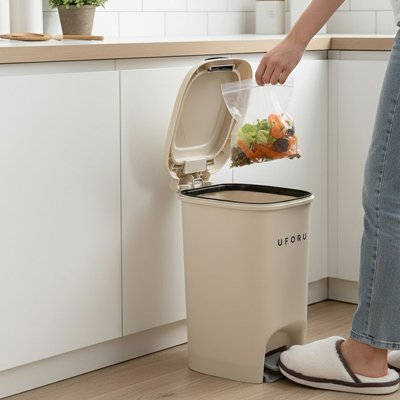 Personne qui dépose sac déchets dans poubelle cuisine 